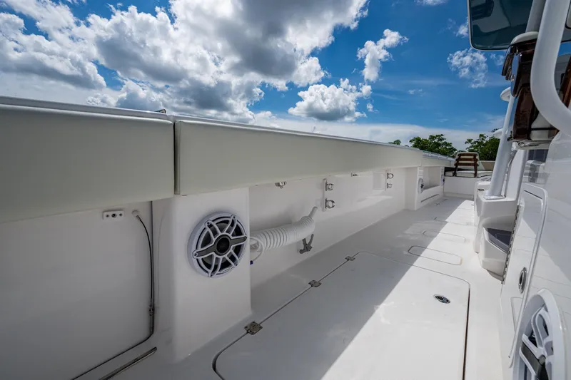 Gotta Go Yacht Photos Pics 2025 Invincible 37 Catamaran deck with speaker, under a partly cloudy sky.