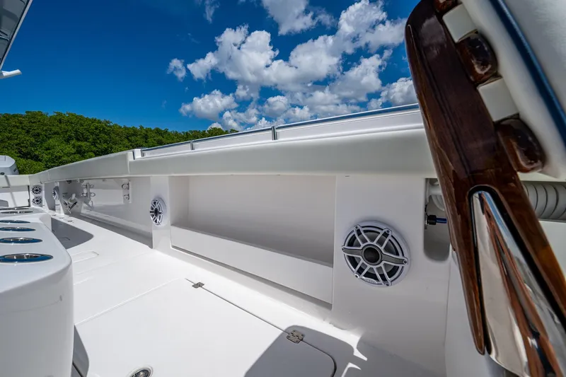 Gotta Go Yacht Photos Pics 2025 Invincible 37 Catamaran deck with speakers, under a bright blue sky.