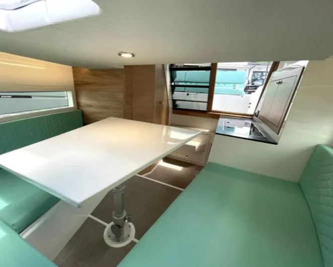  Yacht Photos Pics Interior of 2024 De Antonio Yachts D28 Cruiser with modern seating and table.