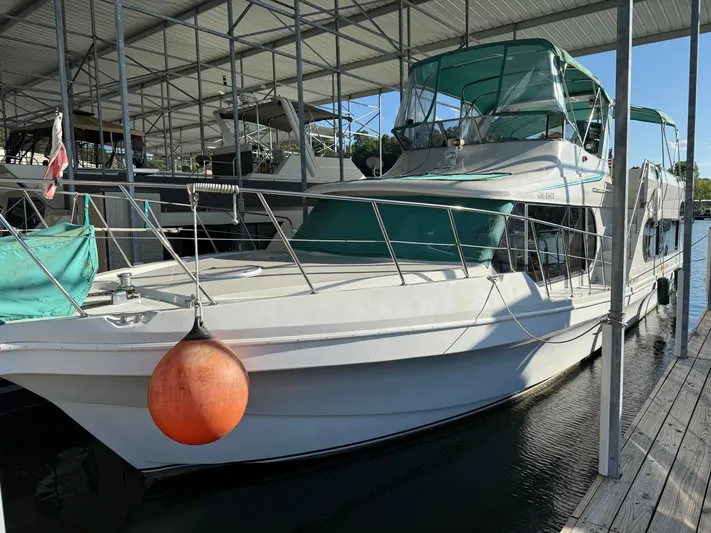 Lexy Lu Yacht Photos Pics 1996 Bluewater Yachts 52 Limited Edition docked under a covered marina.