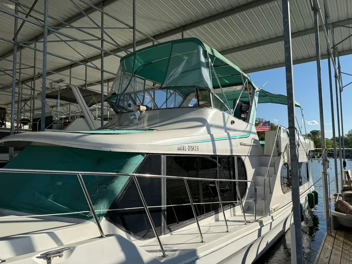 Lexy Lu Yacht Photos Pics 1996 Bluewater Yachts 52 Limited Edition docked under a covered marina.