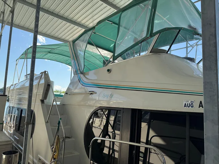 Lexy Lu Yacht Photos Pics 1996 Bluewater Yachts 52 Limited Edition under covered dock with green canopy.