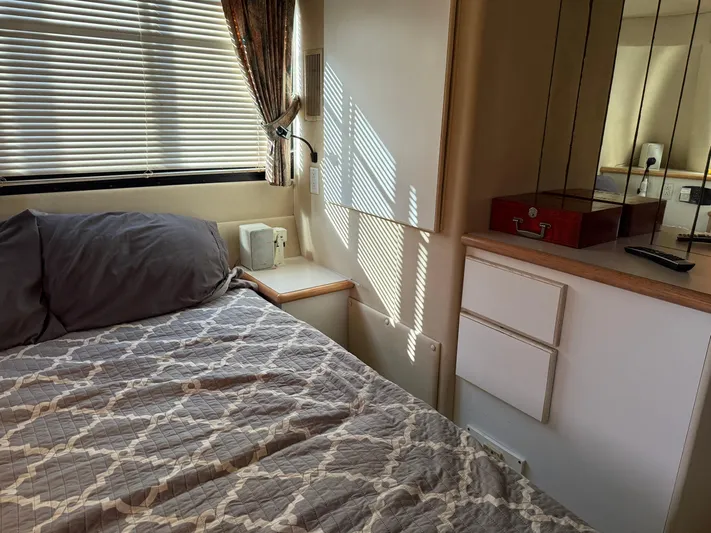 Lexy Lu Yacht Photos Pics Cozy bedroom interior of 1996 Bluewater Yachts 52 Limited Edition with bed and storage.