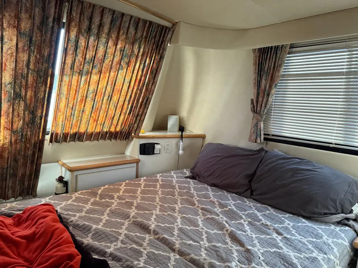 Lexy Lu Yacht Photos Pics Cozy bedroom interior of 1996 Bluewater Yachts 52 Limited Edition with patterned bedding and curtains.
