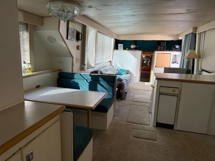 Lexy Lu Yacht Photos Pics Interior of 1996 Bluewater Yachts 52 Limited Edition, featuring dining area and cozy seating.