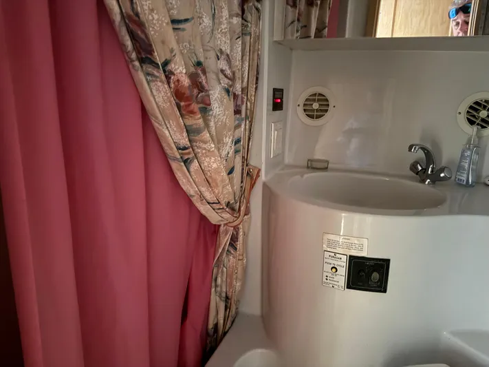 Lexy Lu Yacht Photos Pics Bathroom interior of 1996 Bluewater Yachts 52 Limited Edition with pink and floral curtains.