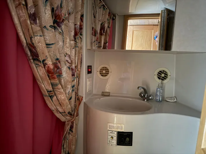 Lexy Lu Yacht Photos Pics Bathroom sink area in 1996 Bluewater Yachts 52 Limited Edition with floral curtains.