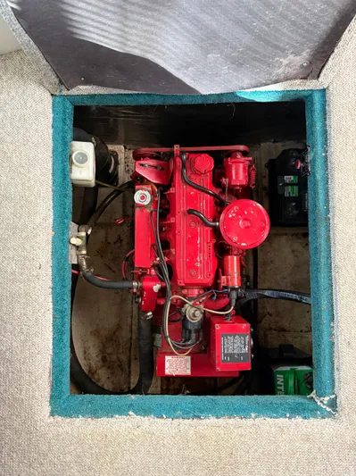 Lexy Lu Yacht Photos Pics Engine compartment of a 1996 Bluewater Yachts 52 Limited Edition, featuring a red engine.