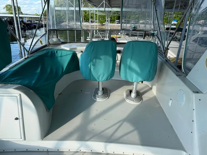 Lexy Lu Yacht Photos Pics 1996 Bluewater Yachts 52 Limited Edition interior with teal seating and helm chairs.