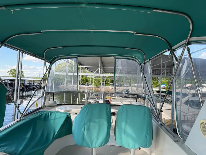 Lexy Lu Yacht Photos Pics 1996 Bluewater Yachts 52 Limited Edition with teal canopy and seating, docked at marina.