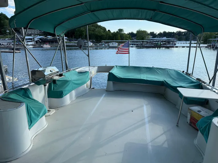 Lexy Lu Yacht Photos Pics 1996 Bluewater Yachts 52 Limited Edition with covered deck, docked by a serene lake.