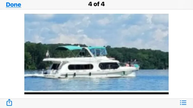 Lexy Lu Yacht Photos Pics A 1996 Bluewater Yachts 52 Limited Edition cruising on a serene lake.