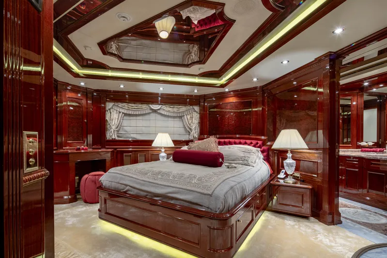 Richar Yacht Photos Pics Luxurious yacht bedroom with elegant wood paneling, plush bedding, and ambient lighting, CRN 185, 2008.
