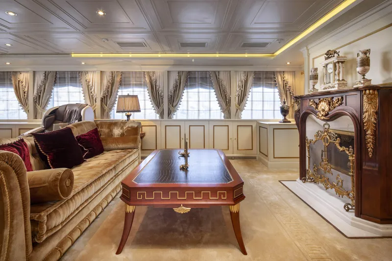 Richar Yacht Photos Pics Luxurious yacht interior with elegant furnishings, ornate fireplace, and plush seating, CRN 185, 2008 model.