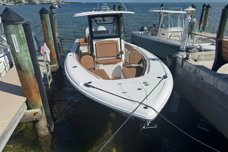  Yacht Photos Pics 2022 Sea Hunt Ultra 305 SE boat docked at marina, featuring sleek design and spacious seating.