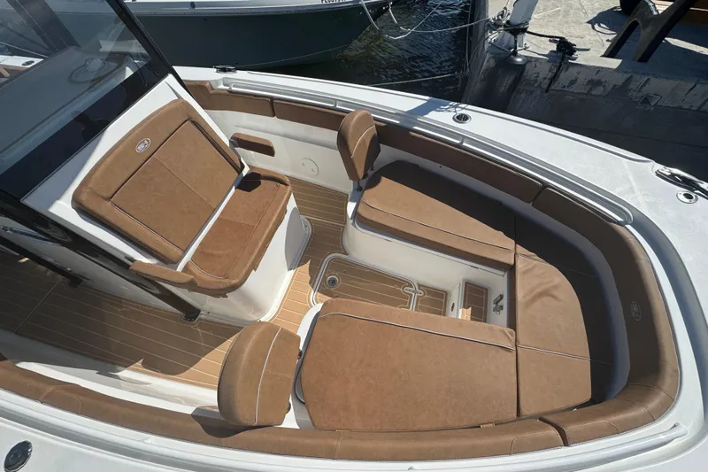  Yacht Photos Pics 2022 Sea Hunt Ultra 305 SE boat interior with brown cushioned seating and sleek design.