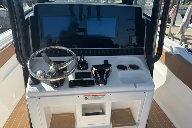  Yacht Photos Pics 2022 Sea Hunt Ultra 305 SE boat dashboard with steering wheel and dual screens.