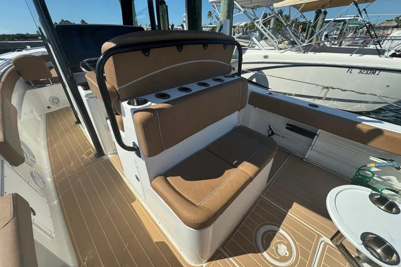  Yacht Photos Pics 2022 Sea Hunt Ultra 305 SE boat interior with tan seating and cup holders.