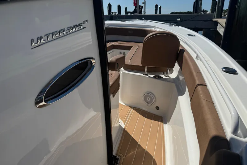  Yacht Photos Pics 2022 Sea Hunt Ultra 305 SE boat interior with brown seating and sleek design.