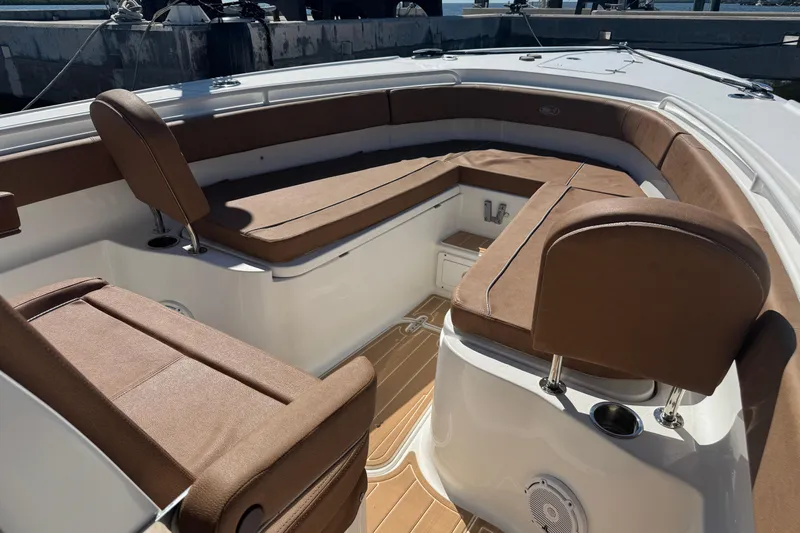  Yacht Photos Pics 2022 Sea Hunt Ultra 305 SE boat interior with brown cushioned seating and white deck.
