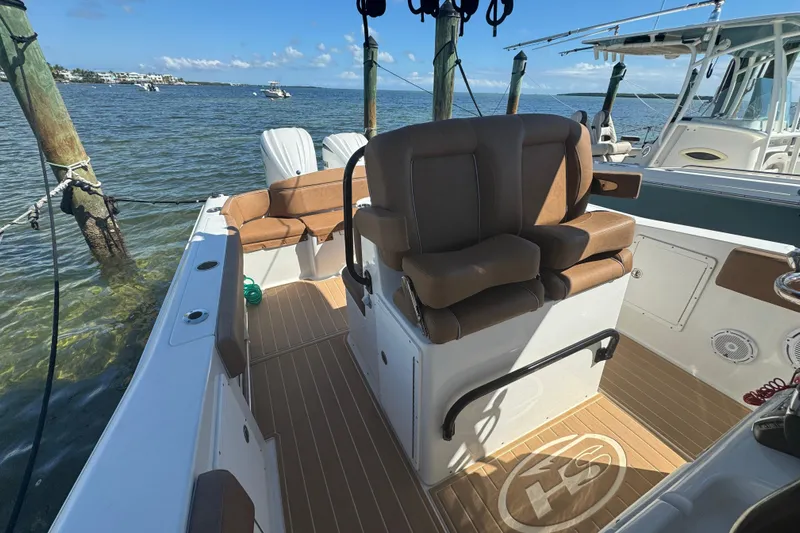  Yacht Photos Pics 2022 Sea Hunt Ultra 305 SE boat interior with brown seating and wood flooring.