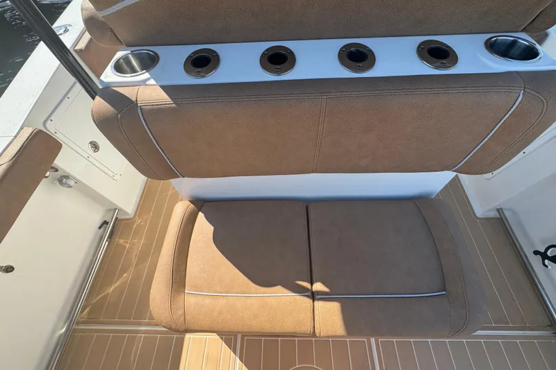  Yacht Photos Pics 2022 Sea Hunt Ultra 305 SE boat seating with cup holders and tan upholstery.
