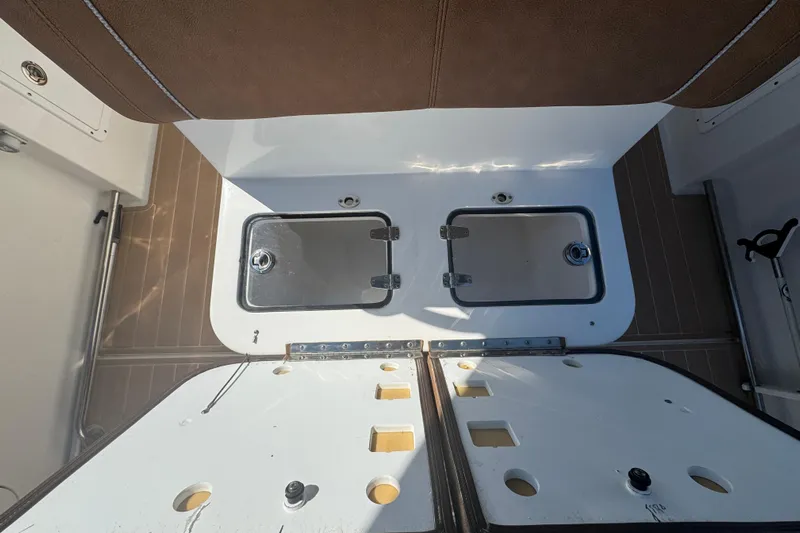  Yacht Photos Pics 2022 Sea Hunt Ultra 305 SE boat interior with storage compartments open.