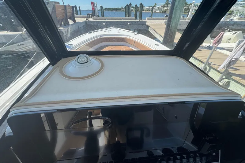  Yacht Photos Pics 2022 Sea Hunt Ultra 305 SE boat dashboard with compass, docked at marina.