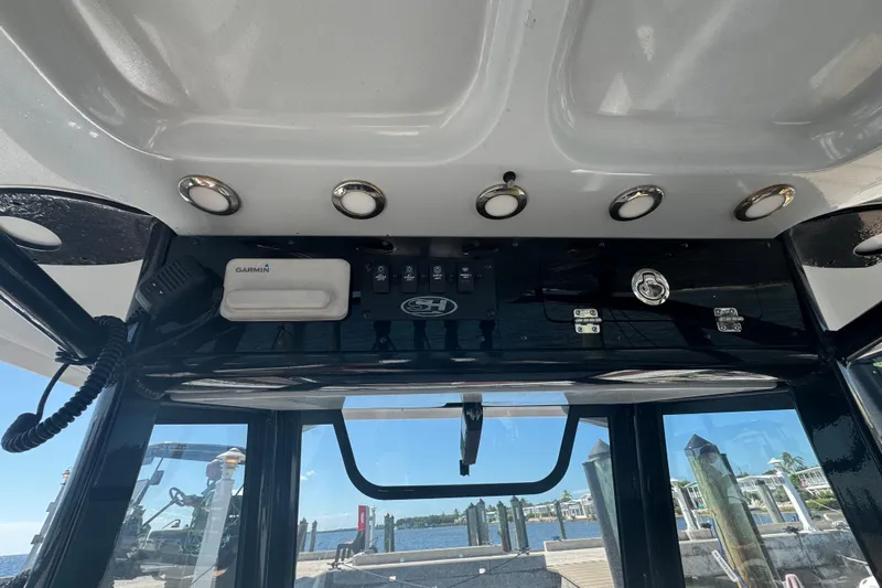  Yacht Photos Pics 2022 Sea Hunt Ultra 305 SE boat dashboard with Garmin device and control panel.