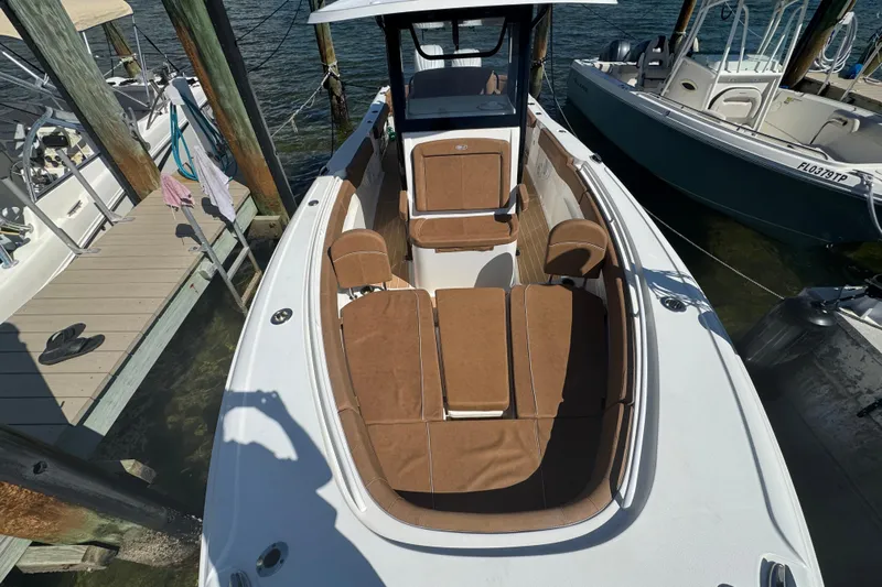  Yacht Photos Pics 2022 Sea Hunt Ultra 305 SE boat docked, featuring spacious seating and sleek design.