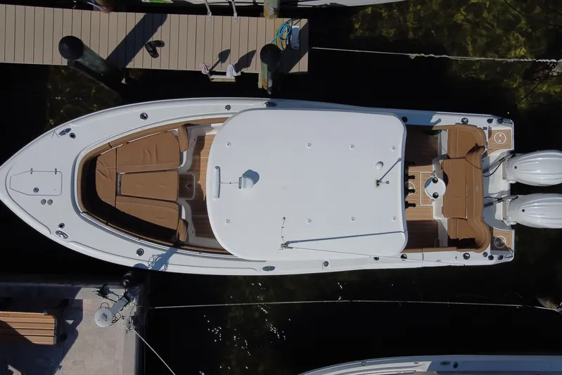  Yacht Photos Pics 2022 Sea Hunt Ultra 305 SE boat docked, aerial view, showcasing spacious deck and twin engines.