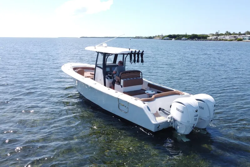  Yacht Photos Pics 2022 Sea Hunt Ultra 305 SE boat on calm water with dual Yamaha engines.