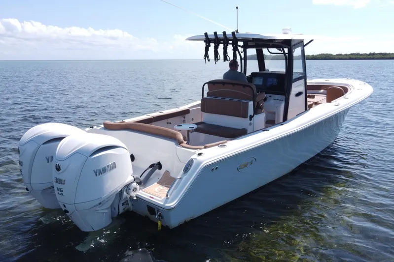  Yacht Photos Pics 2022 Sea Hunt Ultra 305 SE boat with dual Yamaha engines on calm water.