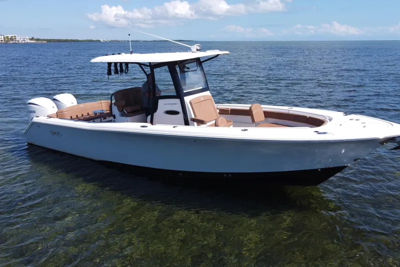  Yacht Photos Pics 2022 Sea Hunt Ultra 305 SE boat on calm water, featuring twin engines and sleek design.