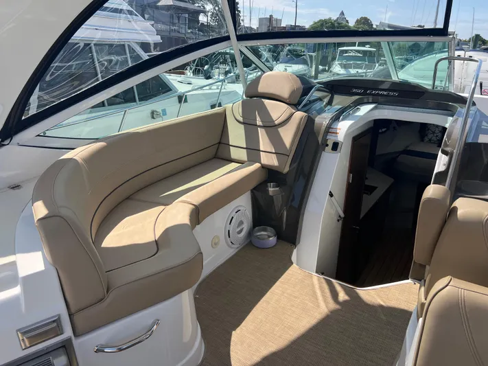 Knot A Care Yacht Photos Pics 2015 Cruisers Yachts 350 Express interior with beige seating and cabin entrance.