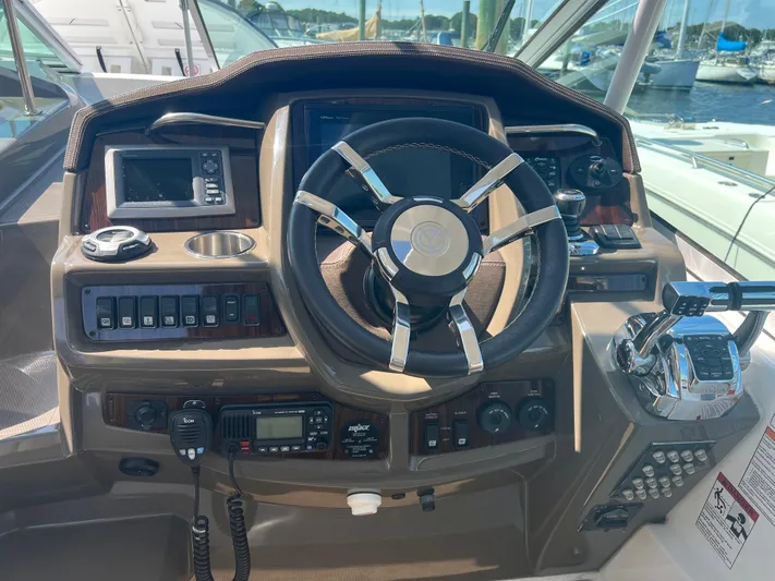 Knot A Care Yacht Photos Pics 2015 Cruisers Yachts 350 Express helm with steering wheel and control panel.