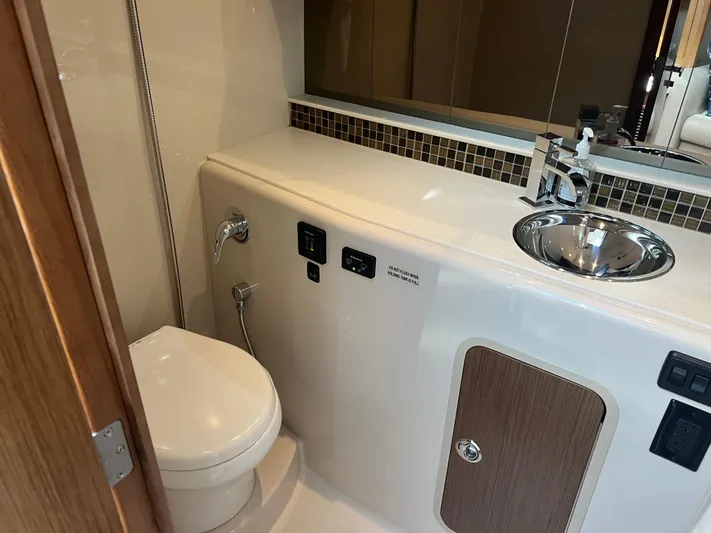 Knot A Care Yacht Photos Pics 2015 Cruisers Yachts 350 Express bathroom with modern sink and toilet.
