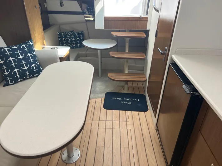 Knot A Care Yacht Photos Pics Interior of 2015 Cruisers Yachts 350 Express with modern seating and wooden flooring.
