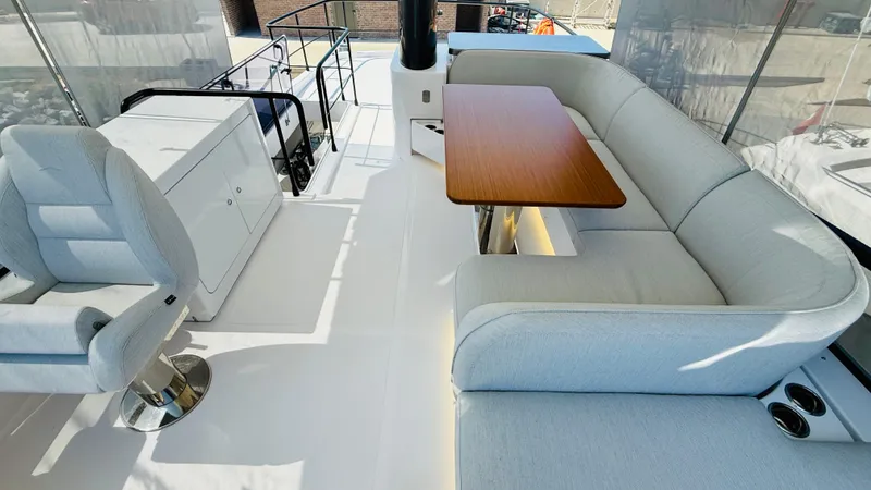  Yacht Photos Pics Luxurious seating area on 2025 Azimut Magellano 60 yacht with modern design and elegant furnishings.