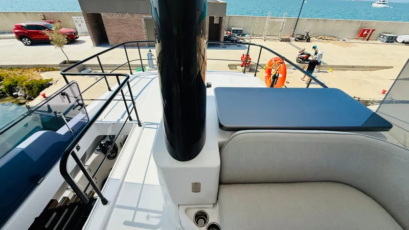  Yacht Photos Pics Azimut Magellano 60 yacht deck, 2025 model, featuring sleek seating and table.