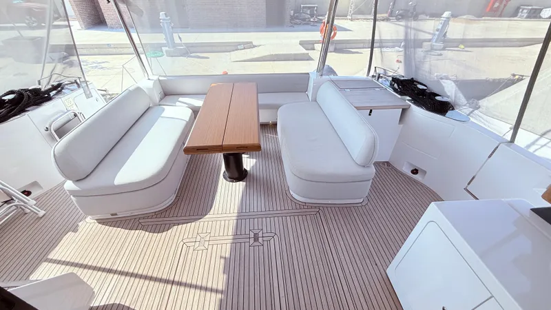  Yacht Photos Pics Luxurious interior of 2025 Azimut Magellano 60 yacht with elegant seating and table.