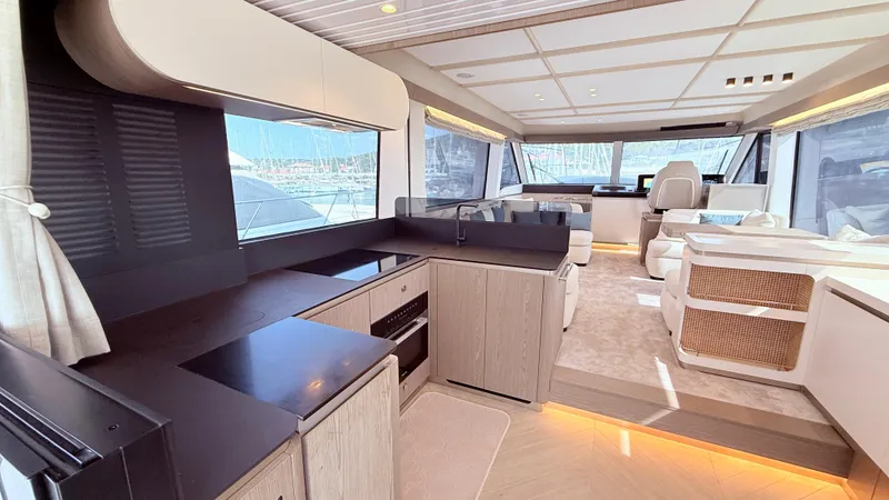  Yacht Photos Pics Luxurious interior of 2025 Azimut Magellano 60 yacht with modern kitchen and seating area.