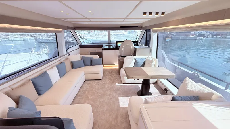  Yacht Photos Pics Luxurious interior of 2025 Azimut Magellano 60 yacht with elegant seating and panoramic windows.
