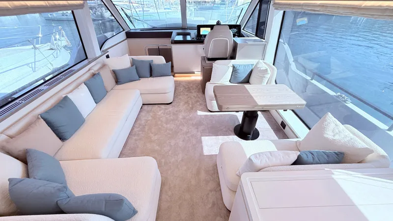  Yacht Photos Pics Luxurious interior of 2025 Azimut Magellano 60 yacht with plush seating and panoramic windows.