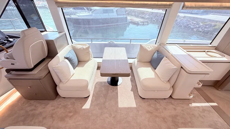  Yacht Photos Pics Luxurious interior of 2025 Azimut Magellano 60 yacht with plush seating and large windows.