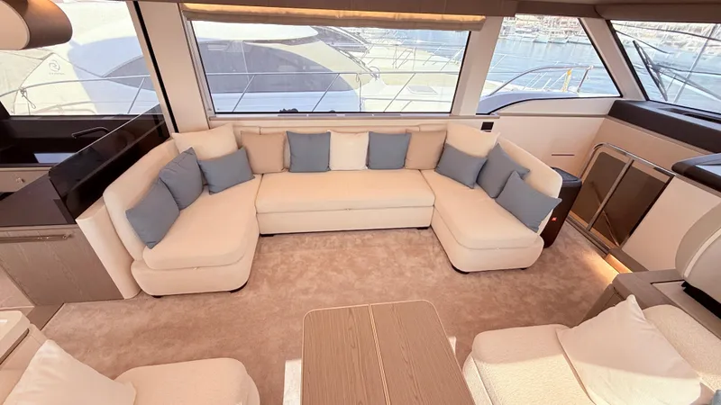  Yacht Photos Pics Luxurious interior of 2025 Azimut Magellano 60 yacht with plush seating and large windows.