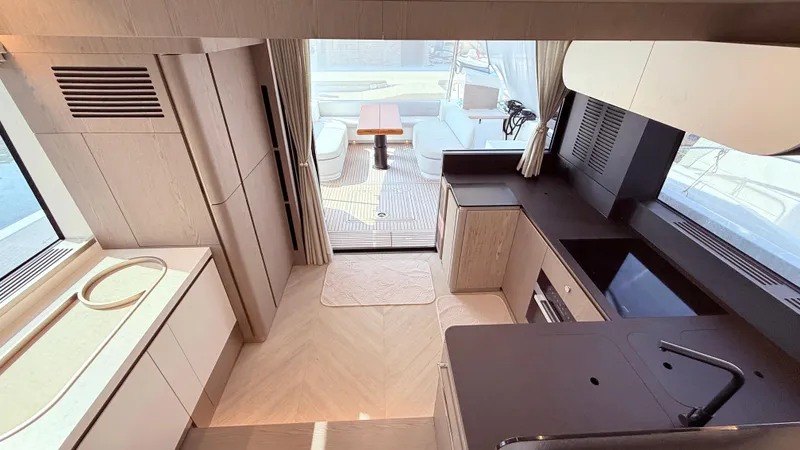  Yacht Photos Pics Luxurious interior of 2025 Azimut Magellano 60 yacht, featuring modern kitchen and dining area.