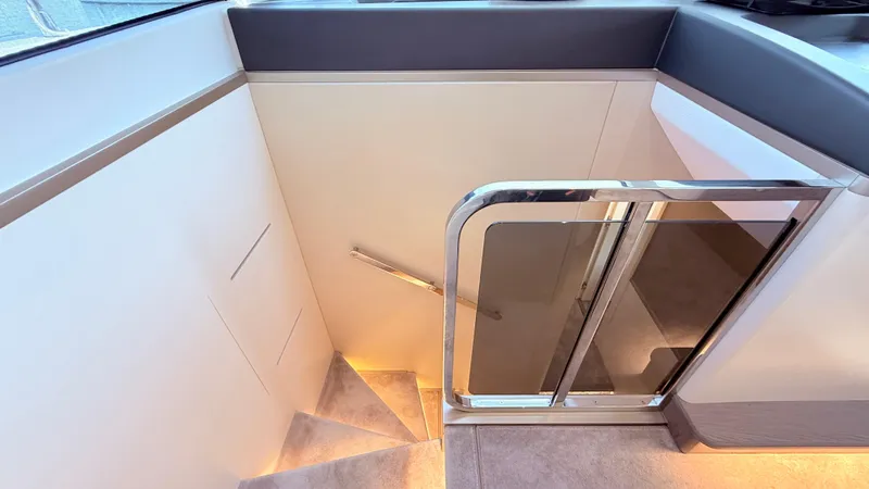  Yacht Photos Pics Staircase with modern railing on 2025 Azimut Magellano 60 yacht, featuring ambient lighting.