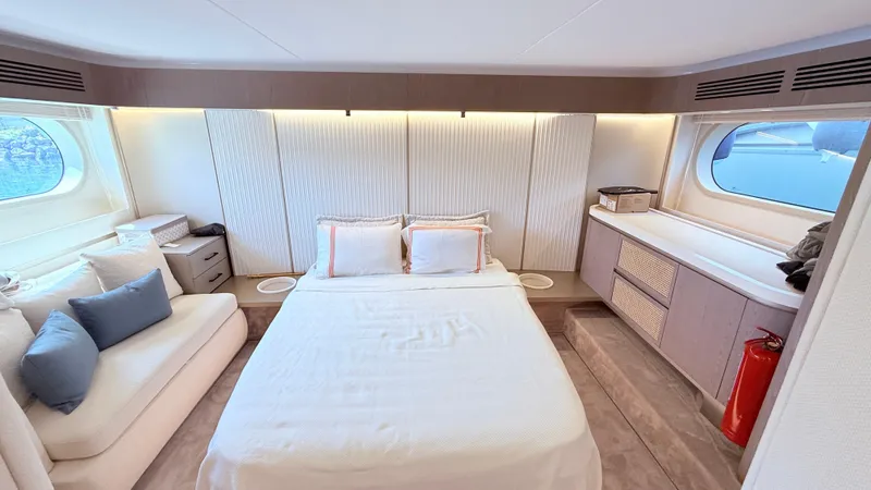  Yacht Photos Pics Luxurious bedroom interior of 2025 Azimut Magellano 60 yacht with modern design and large windows.