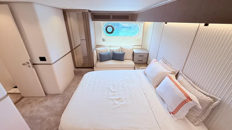  Yacht Photos Pics Luxurious bedroom interior of 2025 Azimut Magellano 60 yacht with elegant decor and window view.